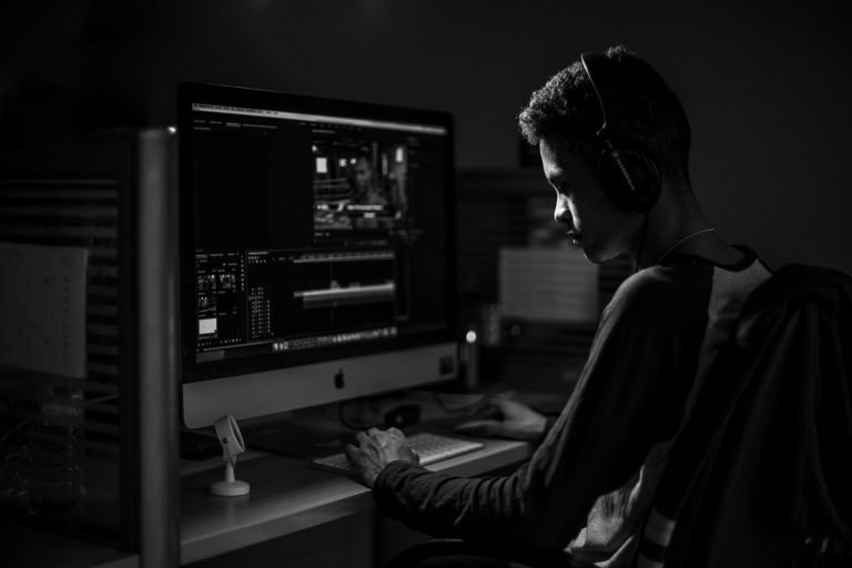 Person sitting at computer on Premiere Pro
